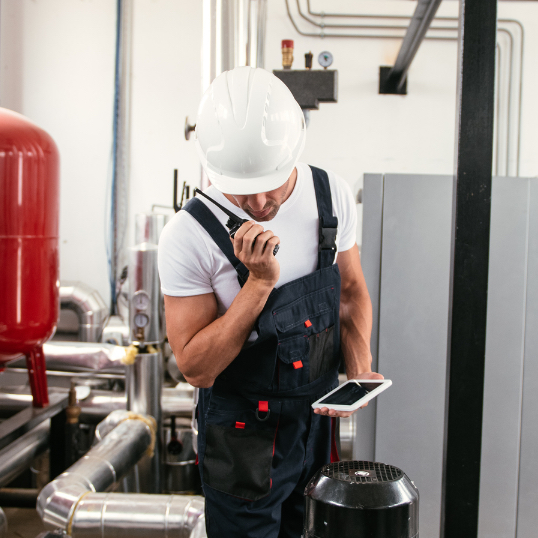 Worker in hard hat using a tablet